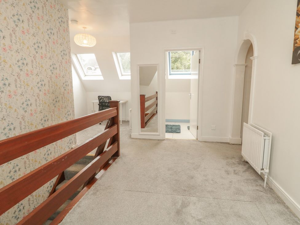 A landing with a mirror and skylight windows at 59 Nursery Avenue in Coleraine