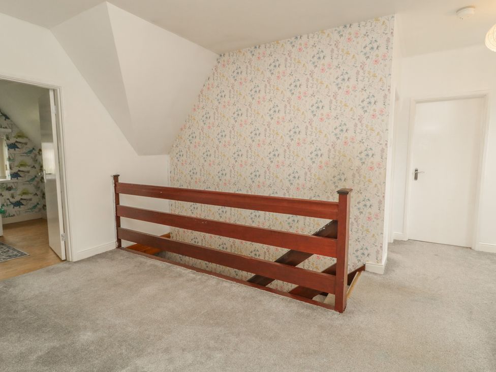 A landing area with a wooden staircase railing at 59 Nursery Avenue, Coleraine