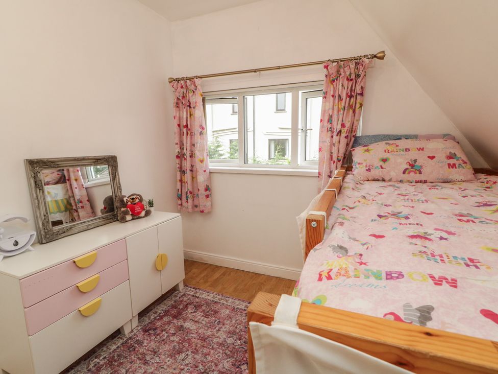 A bedroom with a bed, mirror, drawer unit, and window at 59 Nursery Avenue, Coleraine