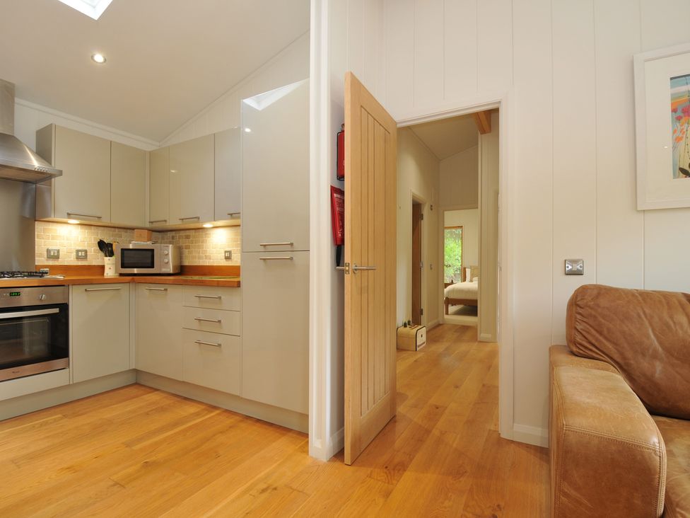 A kitchen with a door leading to other rooms at 11 Water's Edge near Pelynt