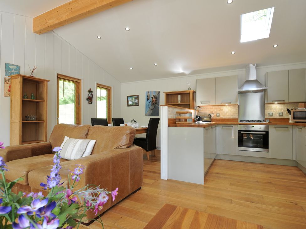 A kitchen with dining table and chairs at 11 Water's Edge near Pelynt