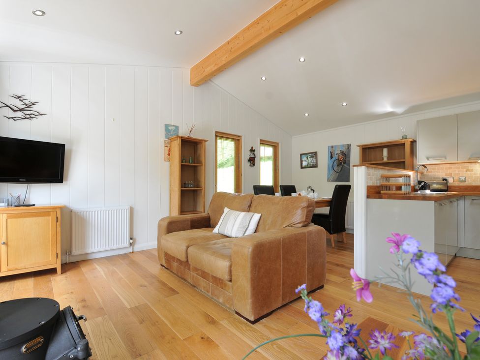 A living room with a sofa and television at 11 Water's Edge near Pelynt