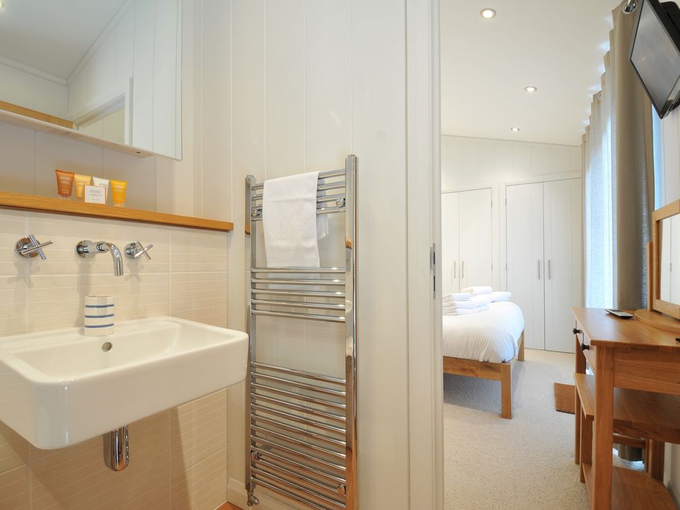 A bathroom with sink and towel rack at 11 Water's Edge near Pelynt