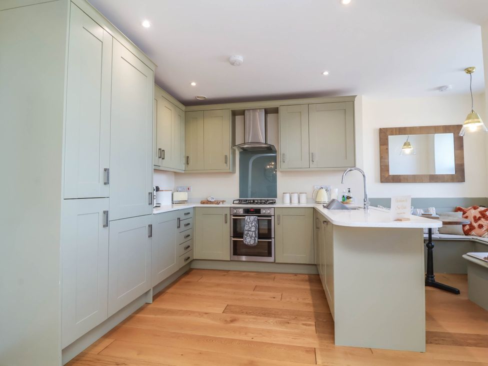 A kitchen with cabinets and appliances at Sea Vista in Westward Ho!