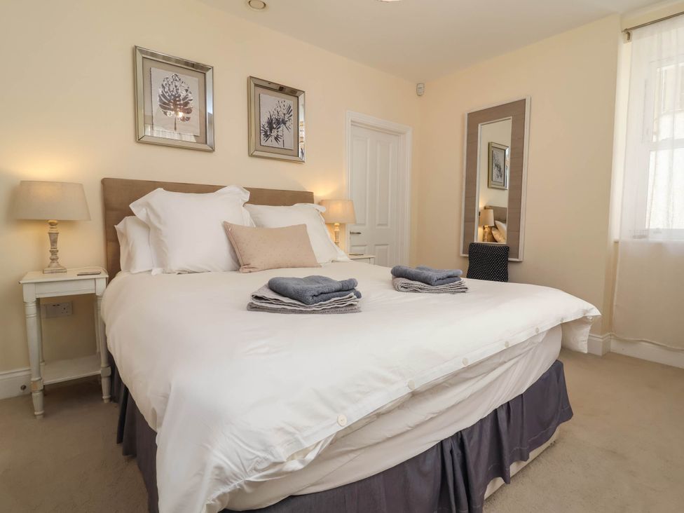 A bedroom with a bed and towels at Sea Vista in Westward Ho!