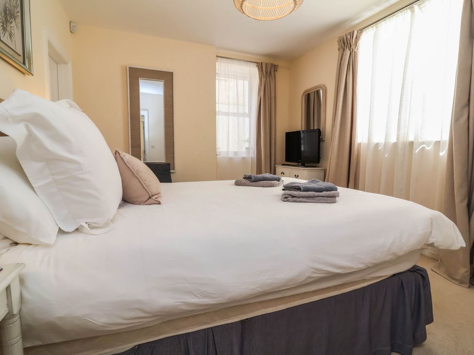 A bedroom with a bed and television at Sea Vista, Westward Ho!