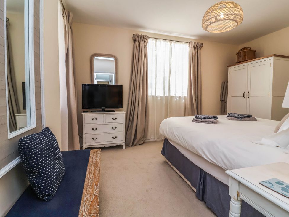 A bedroom with a bed and television at Sea Vista in Westward Ho!