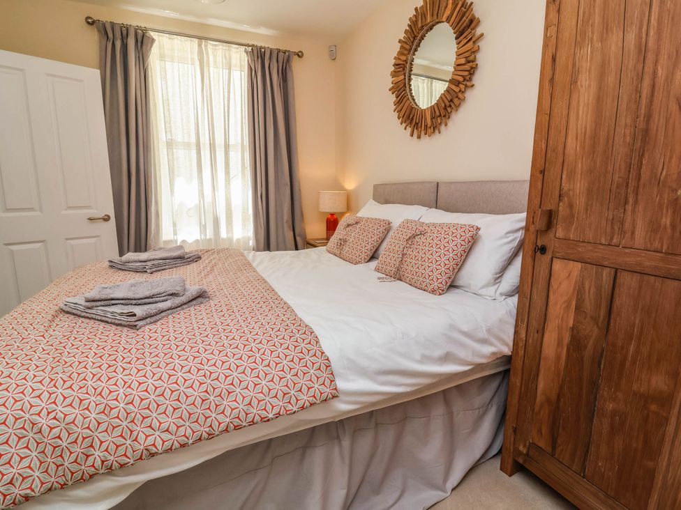 A bedroom with a bed and wardrobe at Sea Vista in Westward Ho!