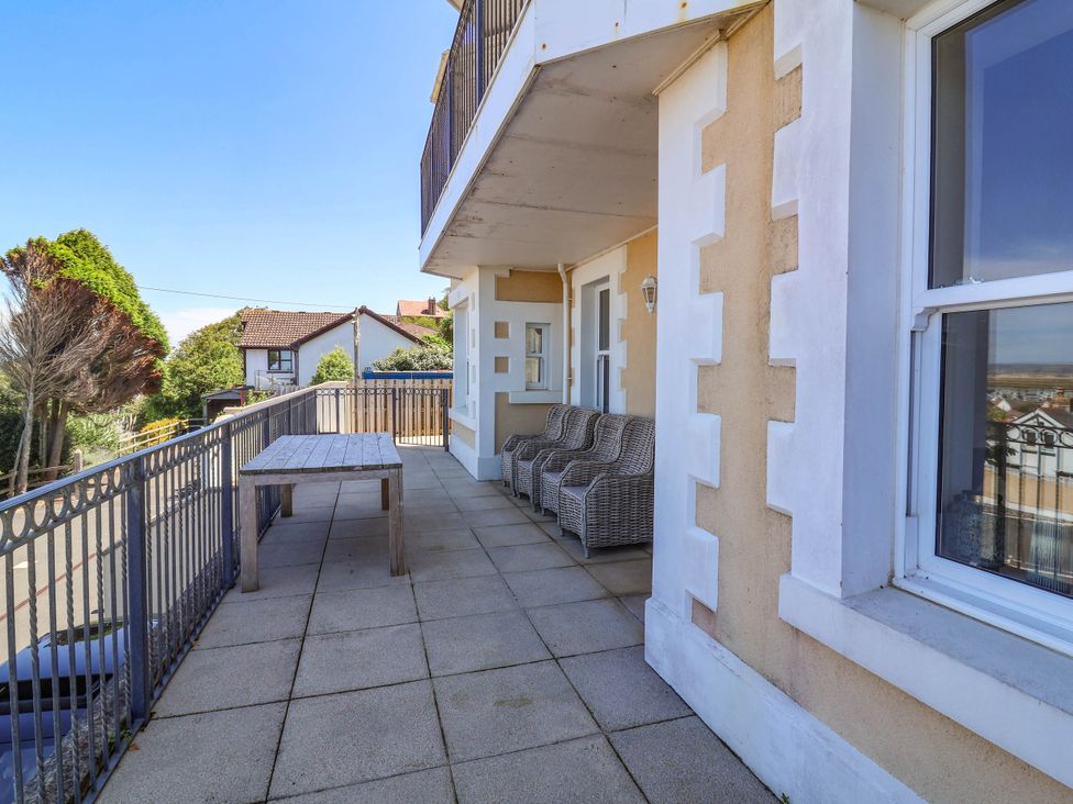 A balcony with a table and chairs at Sea Vista in Westward Ho!