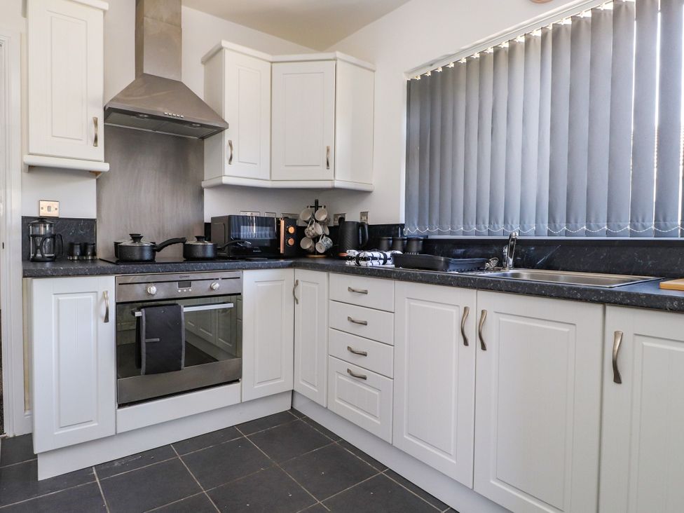 A kitchen with appliances and a countertop at Ger y Mynydd, 2 Cae Ty Coch Brynteg
