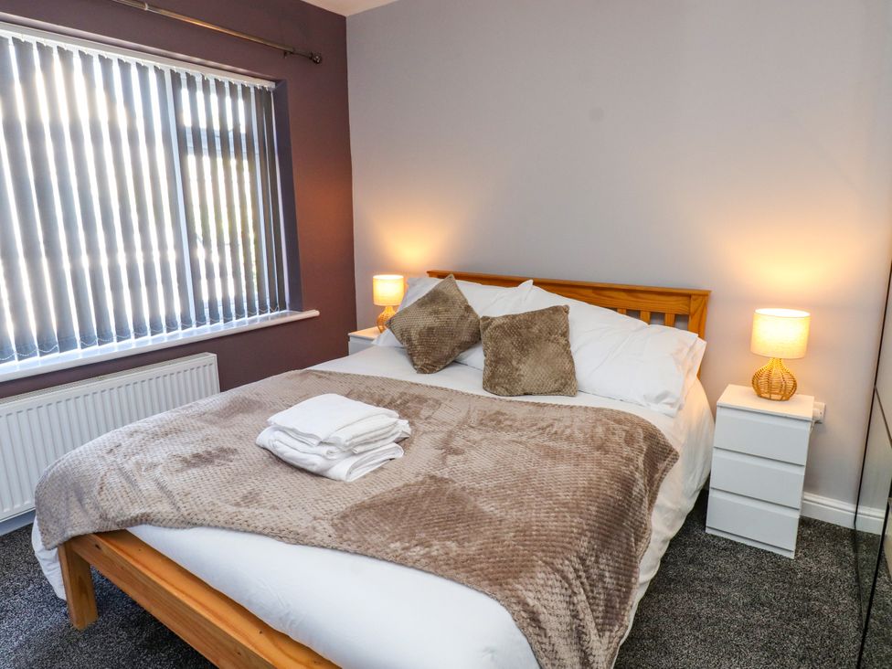 A bedroom with a bed and side tables at Ger y Mynydd, 2 Cae Ty Coch in Brynteg