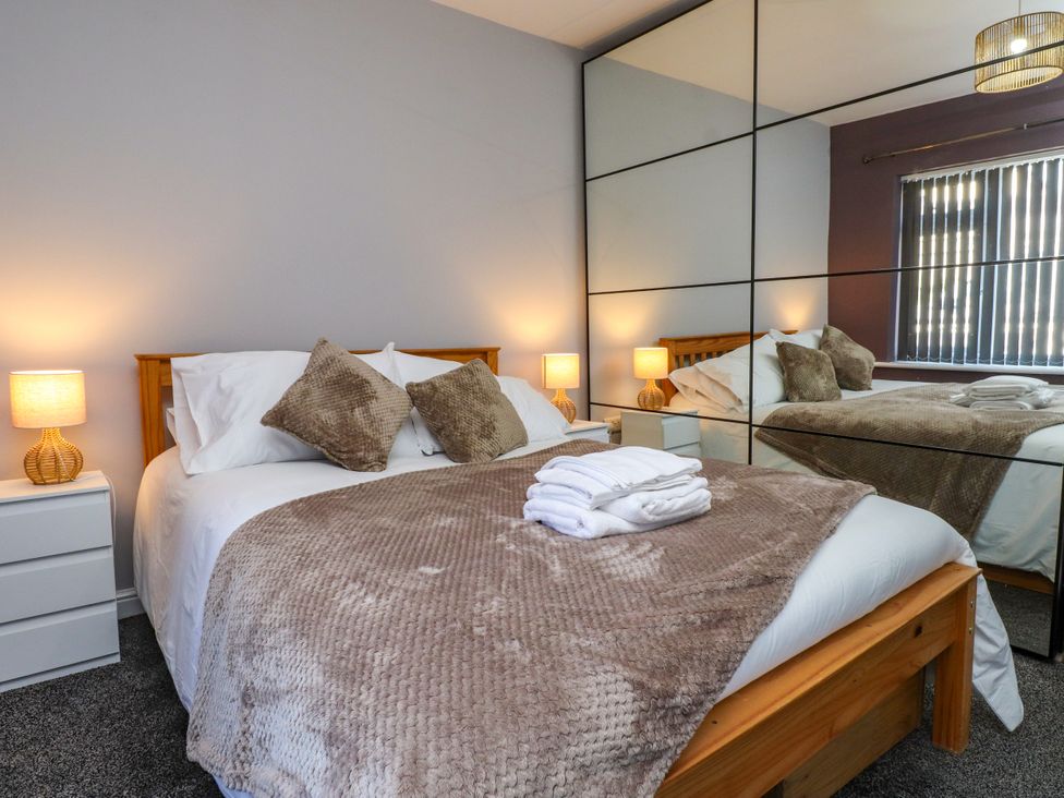 A bedroom with a bed and nightstands at Ger y Mynydd, 2 Cae  Ty Coch in Brynteg