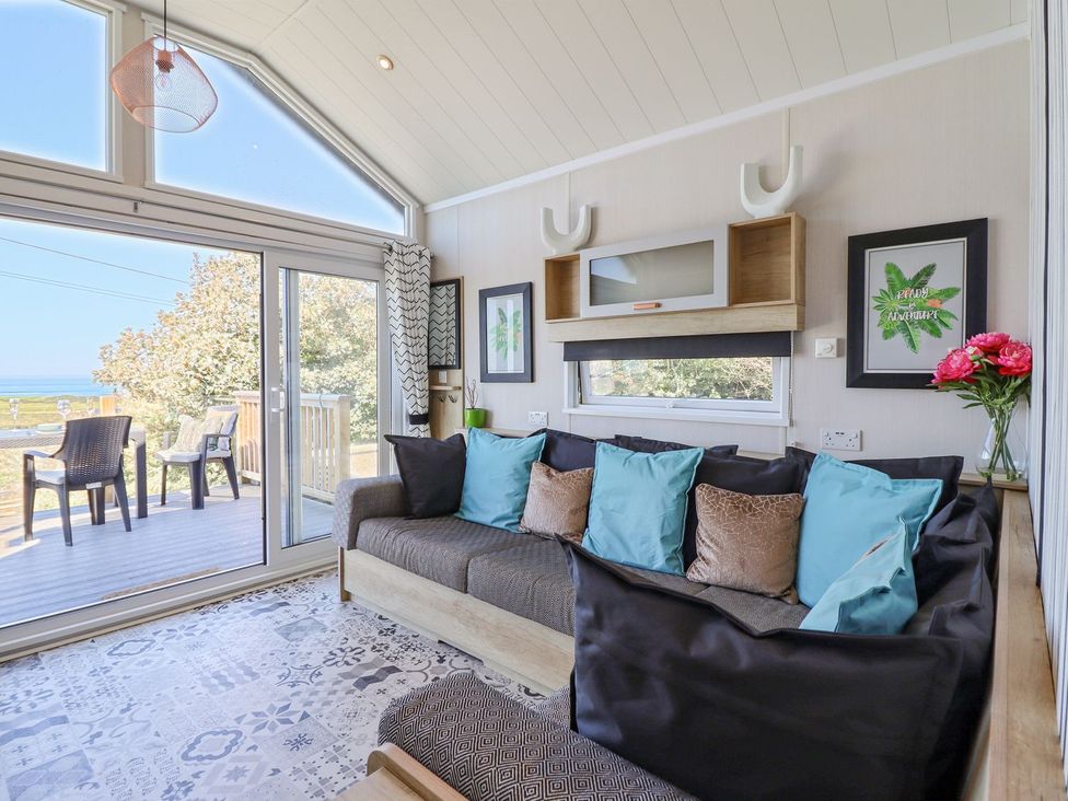 A living room with a sofa and coffee table at Posh Pod in Cemaes Bay