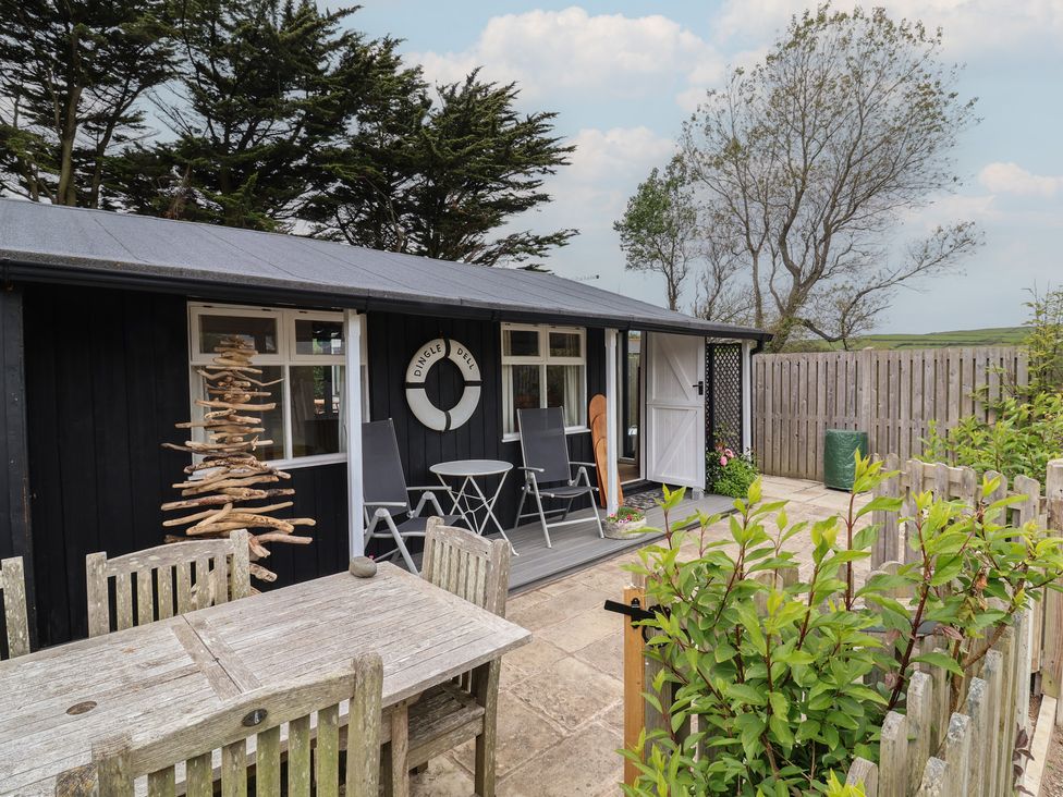 An outdoor area with seating and a decorative tree at Dingle Dell in Braunton