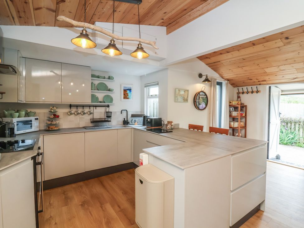 A kitchen with cabinets and appliances at Dingle Dell Braunton