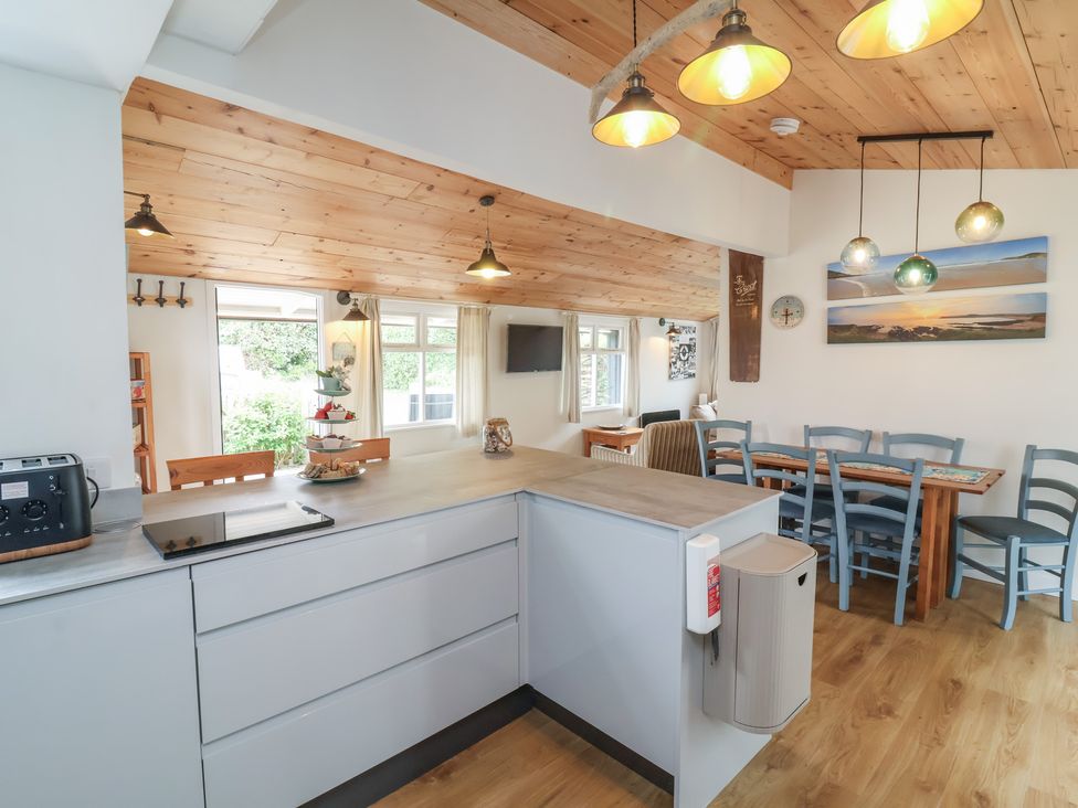 A kitchen with a countertop and dining area at Dingle Dell in Braunton