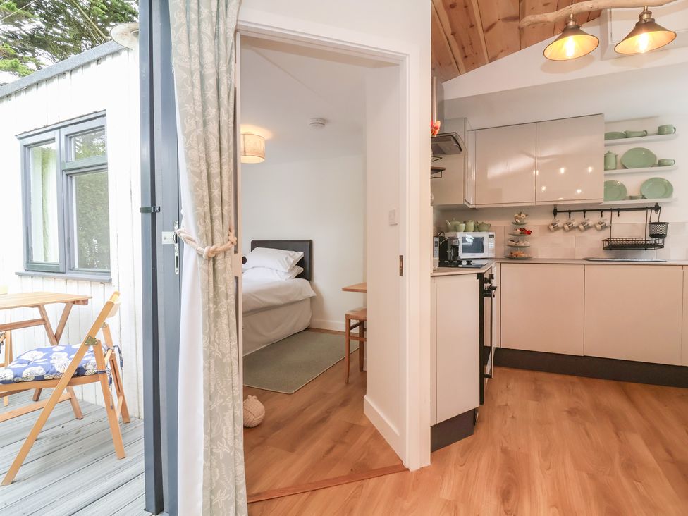 A kitchen with a table and chairs at Dingle Dell in Braunton