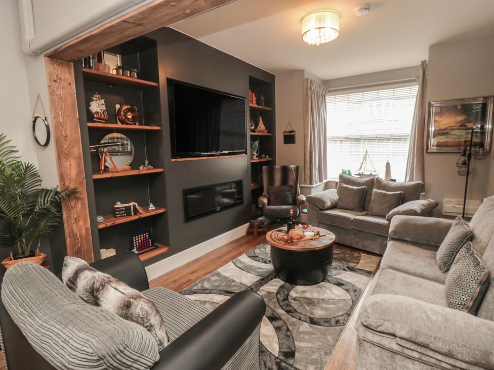 A living room with a TV and seating area at Memory Maker in Bridlington