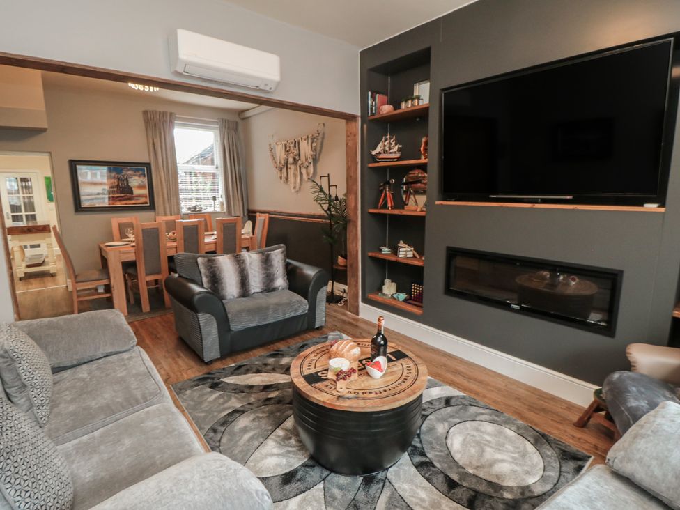 A living room with a sofa and dining table at Memory Maker in Bridlington