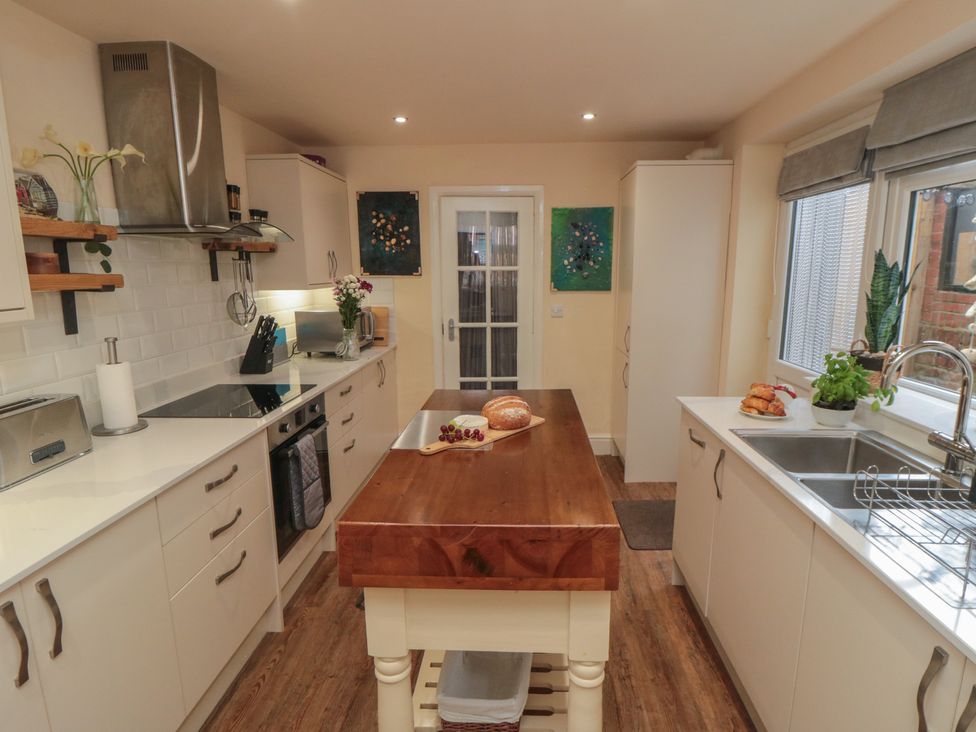A kitchen with a counter, sink, and stove at Memory Maker in Bridlington
