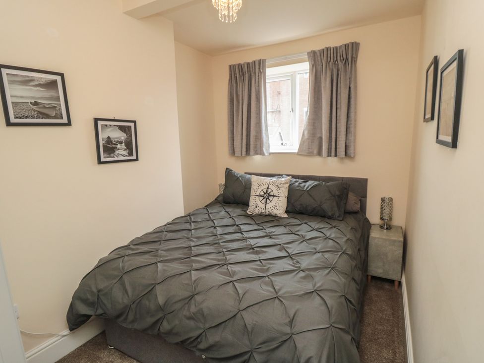 A bedroom with a bed and bedside table at Memory Maker in Bridlington