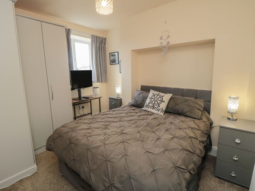 A bedroom with a bed and television at Memory Maker in Bridlington