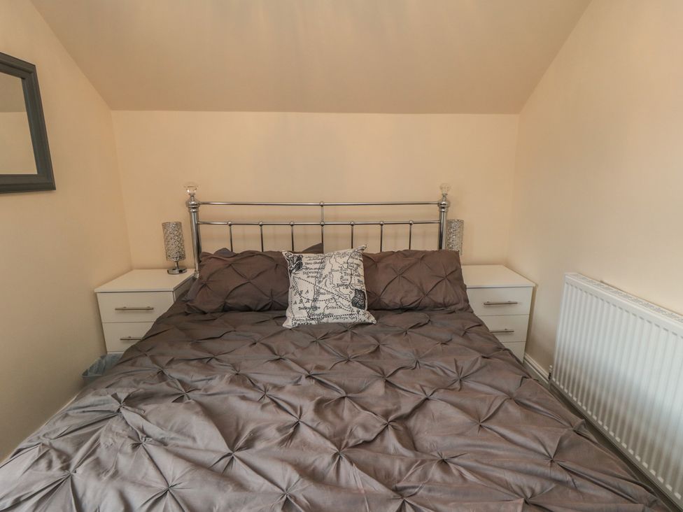 A bedroom with a bed and bedside tables at Memory Maker in Bridlington