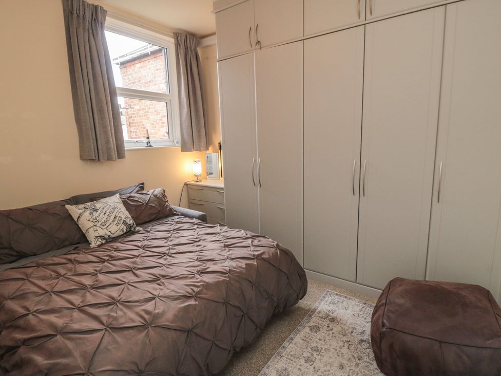 A bedroom with a bed and wardrobe at Memory Maker in Bridlington