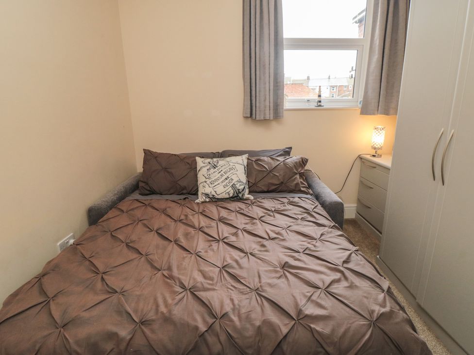 A bedroom with a bed and wardrobe at Memory Maker in Bridlington