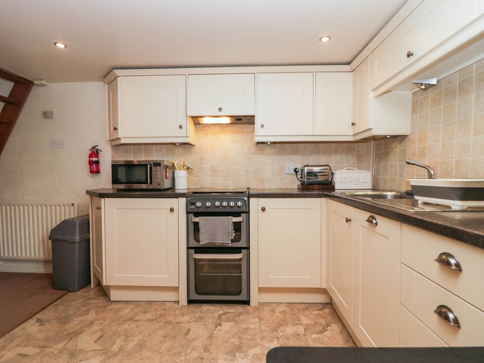 A kitchen with an oven, microwave, and sink at Rooftops Lindale