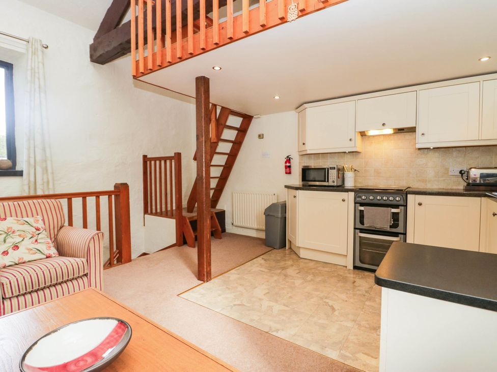 A kitchen with a stove and microwave at Rooftops in Lindale