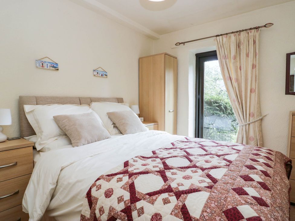A bedroom with a bed and wardrobe at Rooftops in Lindale