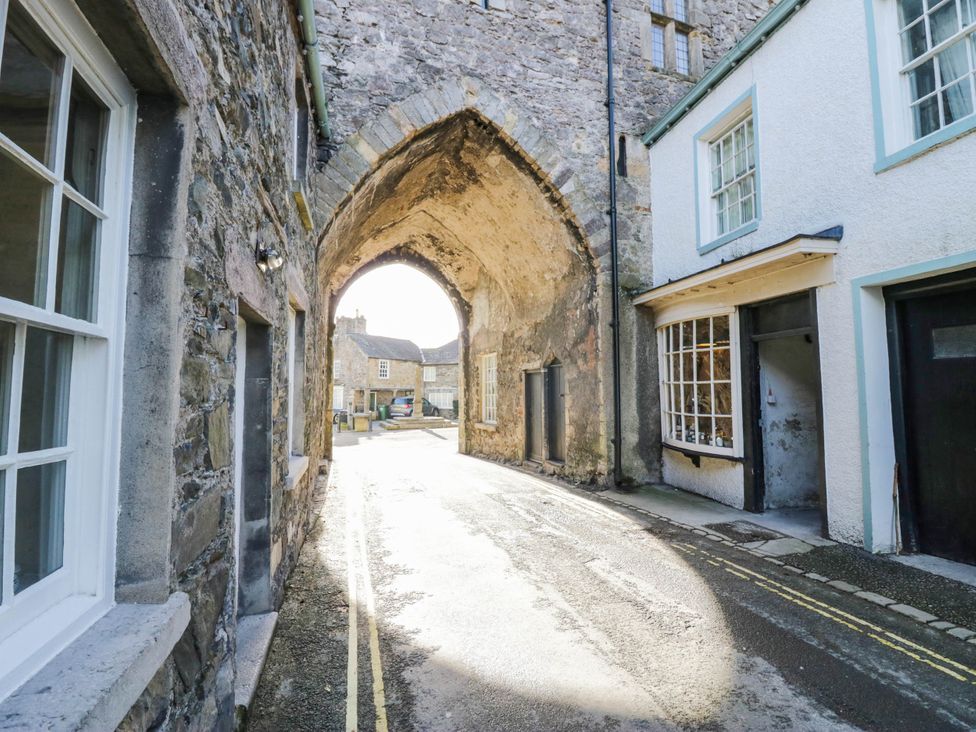 An outdoor area with a stone archway and buildings at Rooftops Lindale