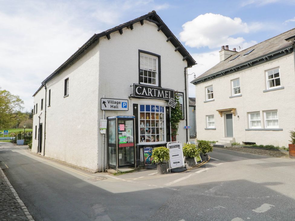 A shop with a sign and parking information at Cartmel in Lindale