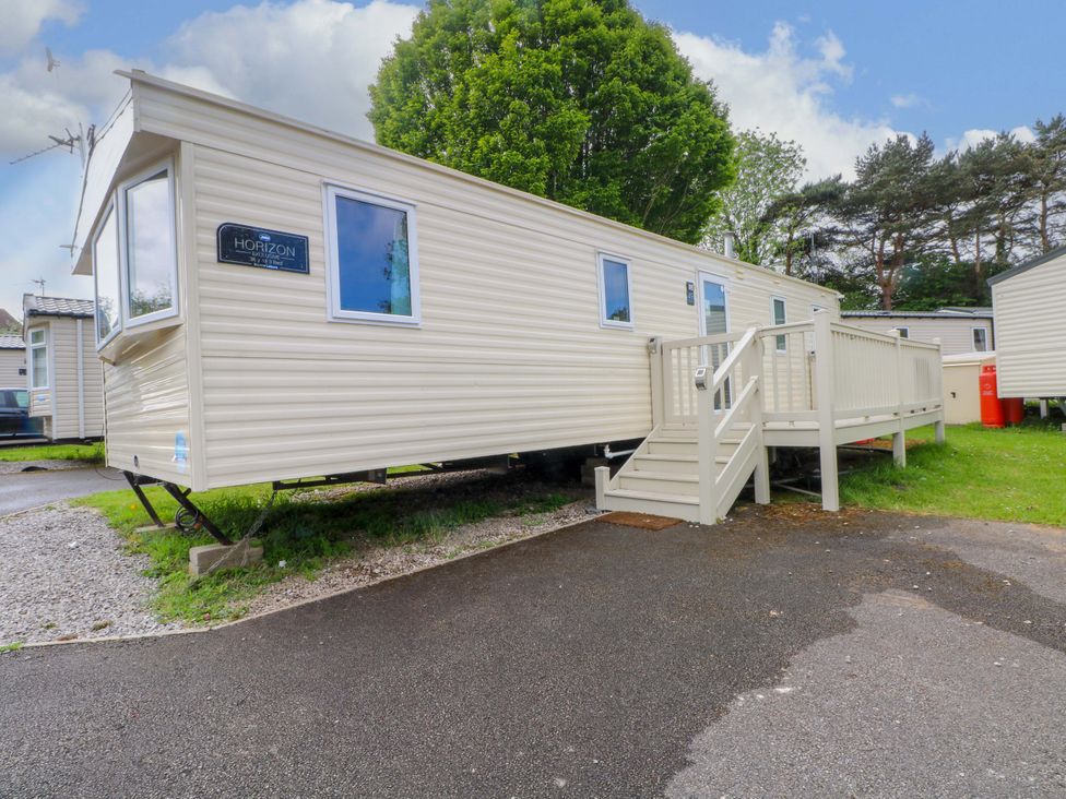 A mobile home with steps and deck at Kensington 49