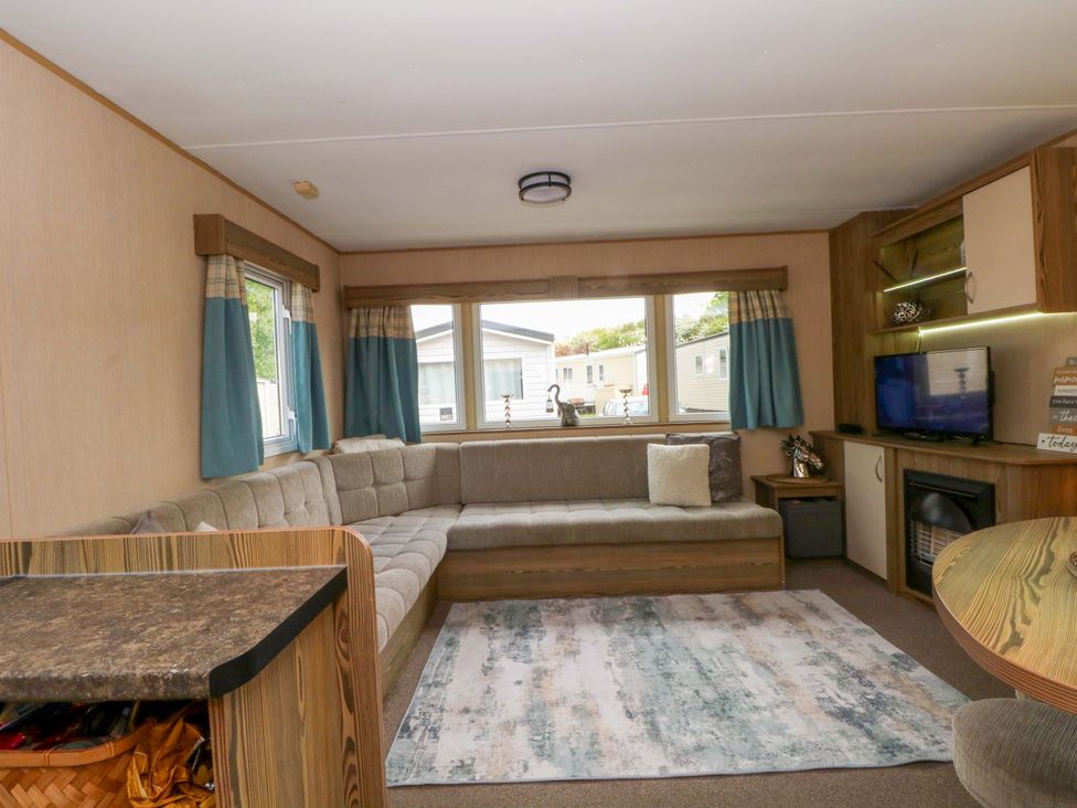 A living room with a sofa and television at Kensington 49