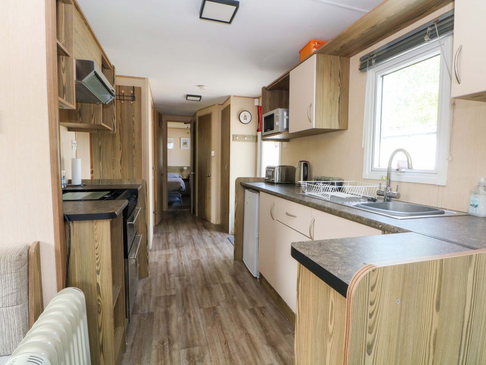 A kitchen with appliances and cabinets at Kensington 49