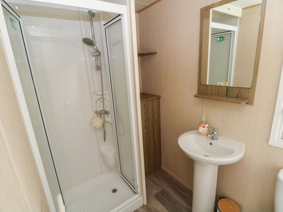 A bathroom with shower and sink at Kensington 49