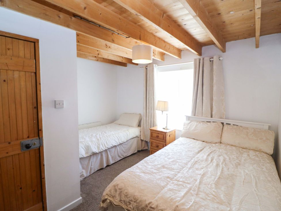 A bedroom with two beds and a bedside table at Tach Ferme