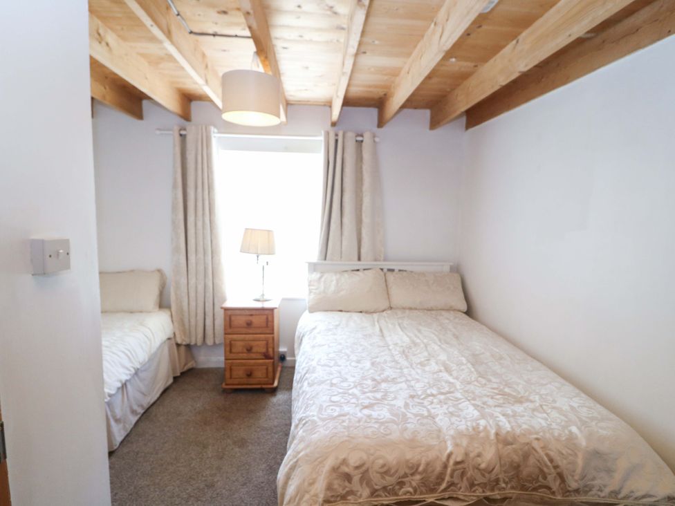 A bedroom with two beds and a bedside table at Tach Ferme