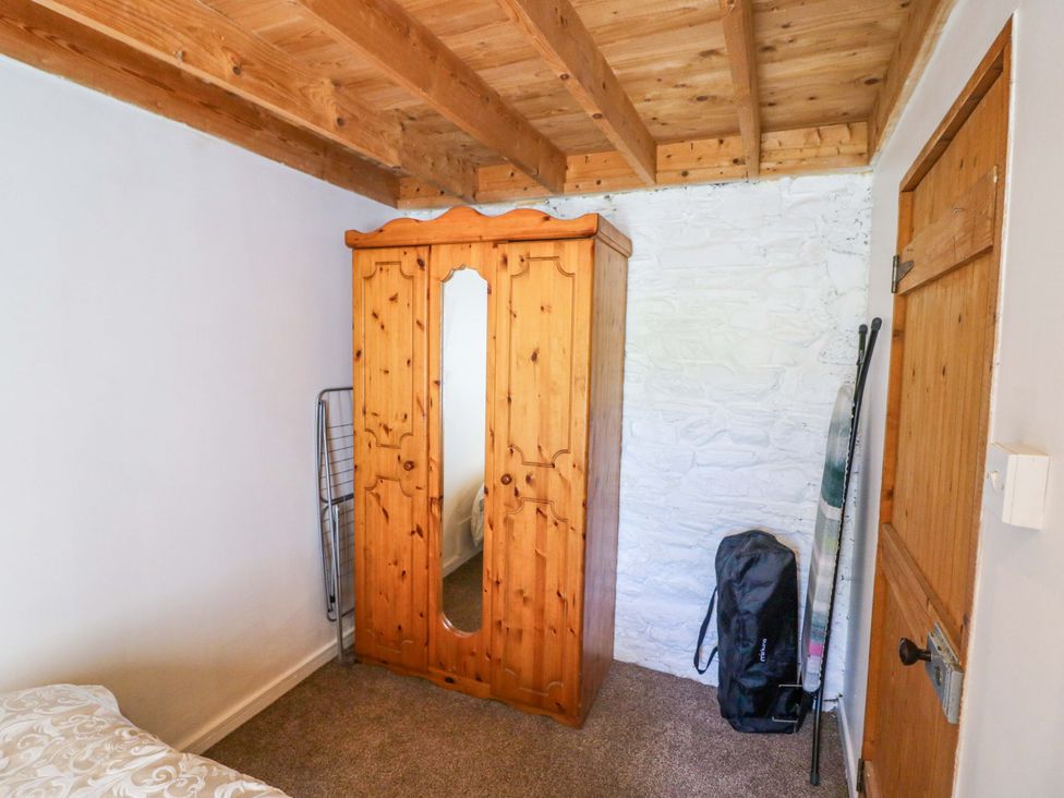 A bedroom with a wooden wardrobe and a backpack at Tach Ferme