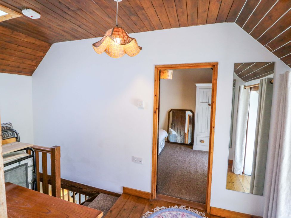 A bedroom with a mirror and wardrobe at Tach Ferme