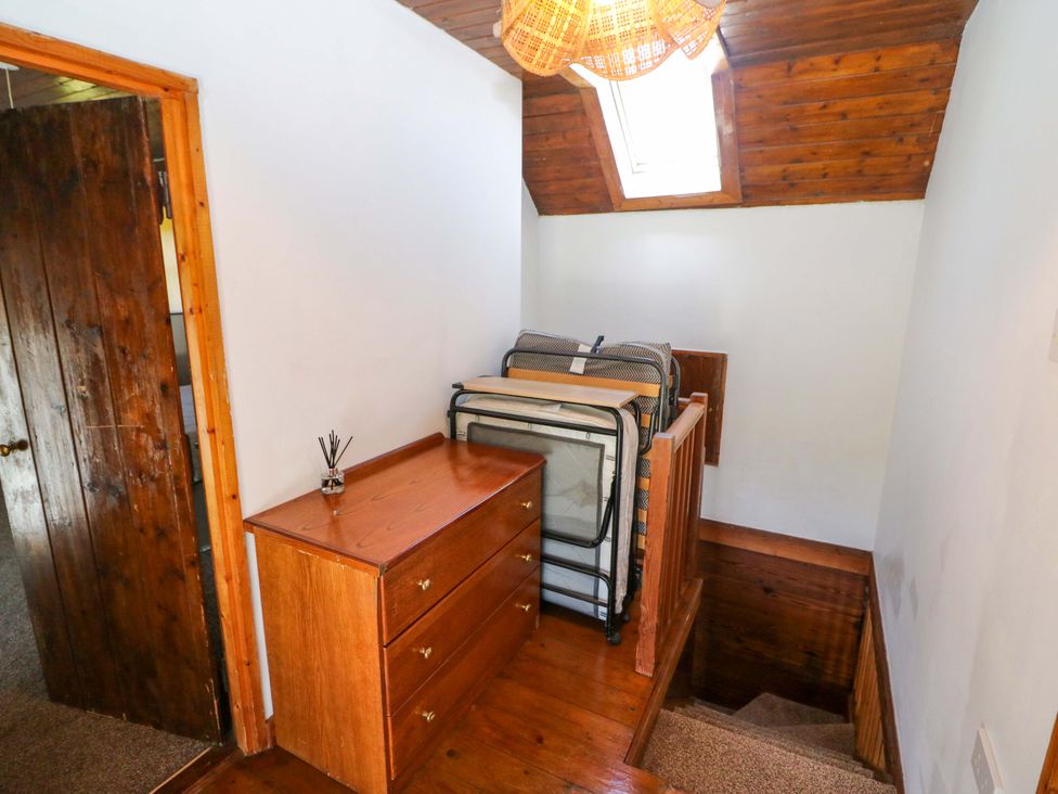 A staircase with a chest of drawers and folding beds at Tach Ferme in 