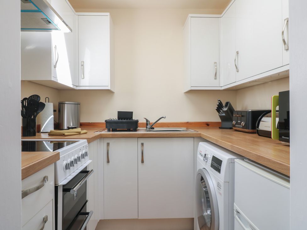 A kitchen with sink, oven, washing machine at 27a Wolds Drive Nottingham