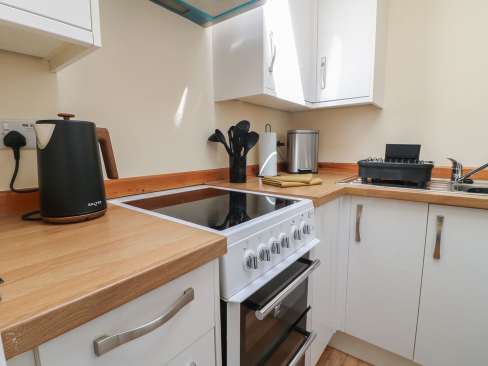 A kitchen with modern appliances and utensils at 27a Wolds Drive in Nottingham