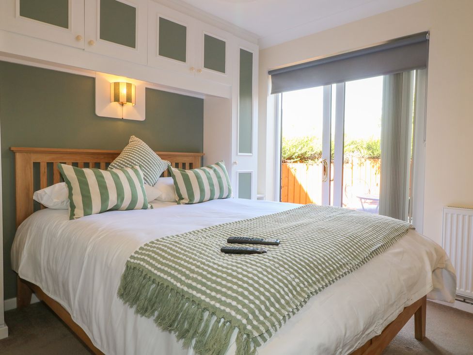 A bedroom with a bed and windows at 27a Wolds Drive Nottingham