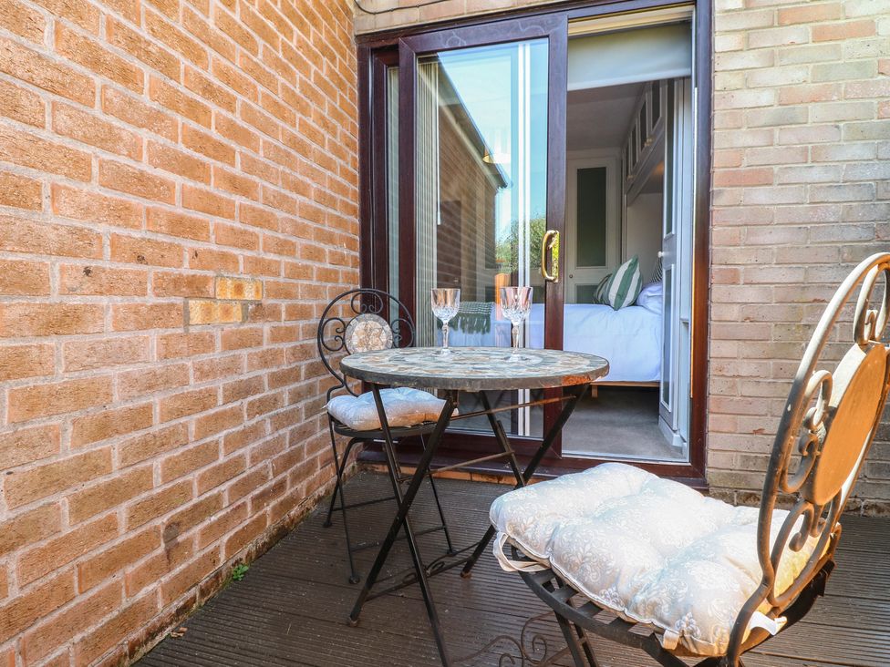 A balcony with a table and chairs at 27a Wolds Drive Nottingham