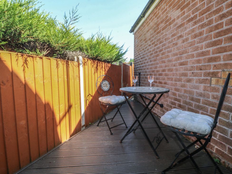 An outdoor area with a table and chairs at 27a Wolds Drive Nottingham