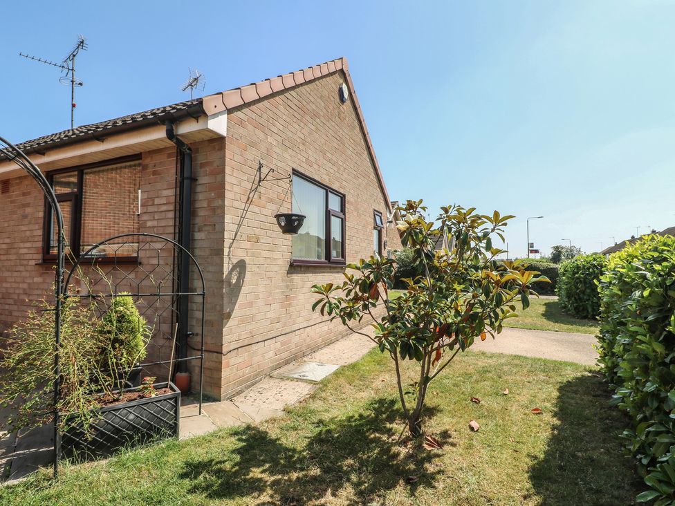 A side view of a house with a garden and pathway at 27a Wolds Drive Nottingham