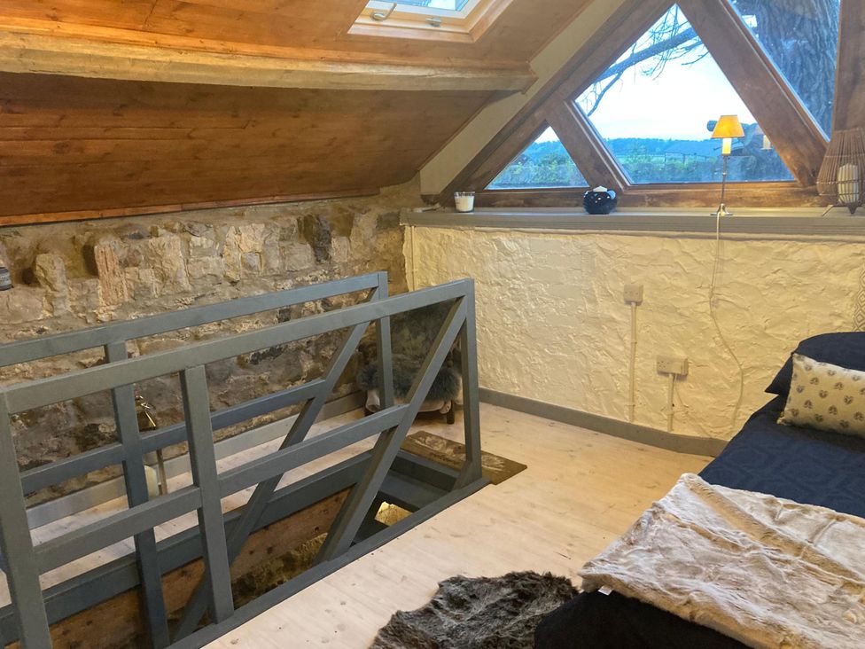 A bedroom with a bed and skylights at 1-Bed Barn Conversion, Sleeps 2 with Parking in Niwbwrch (newborough)